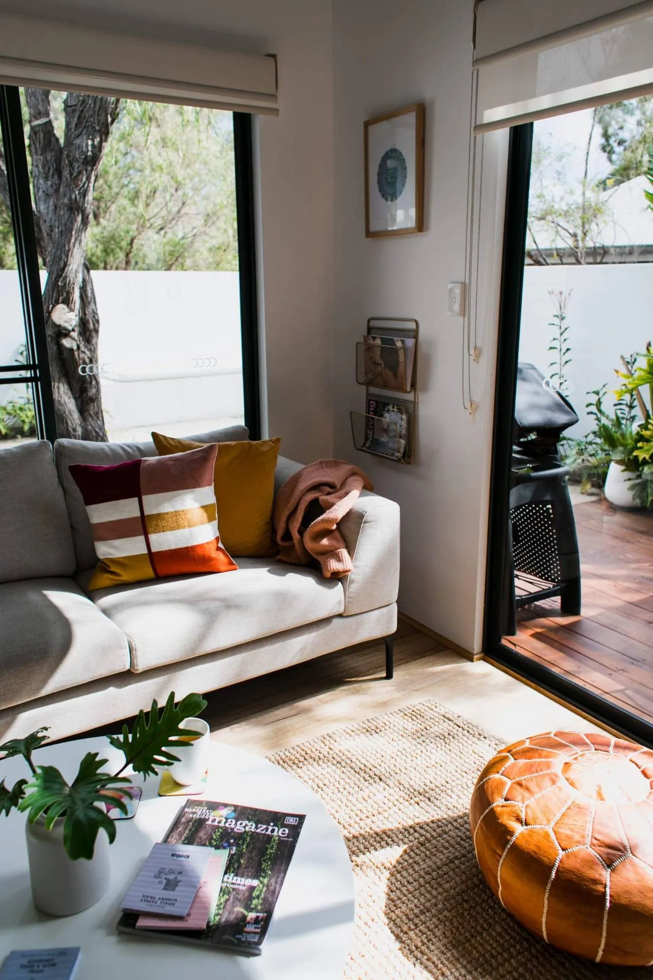 Cosy sofa corner in morning light with cushions and a jute rug